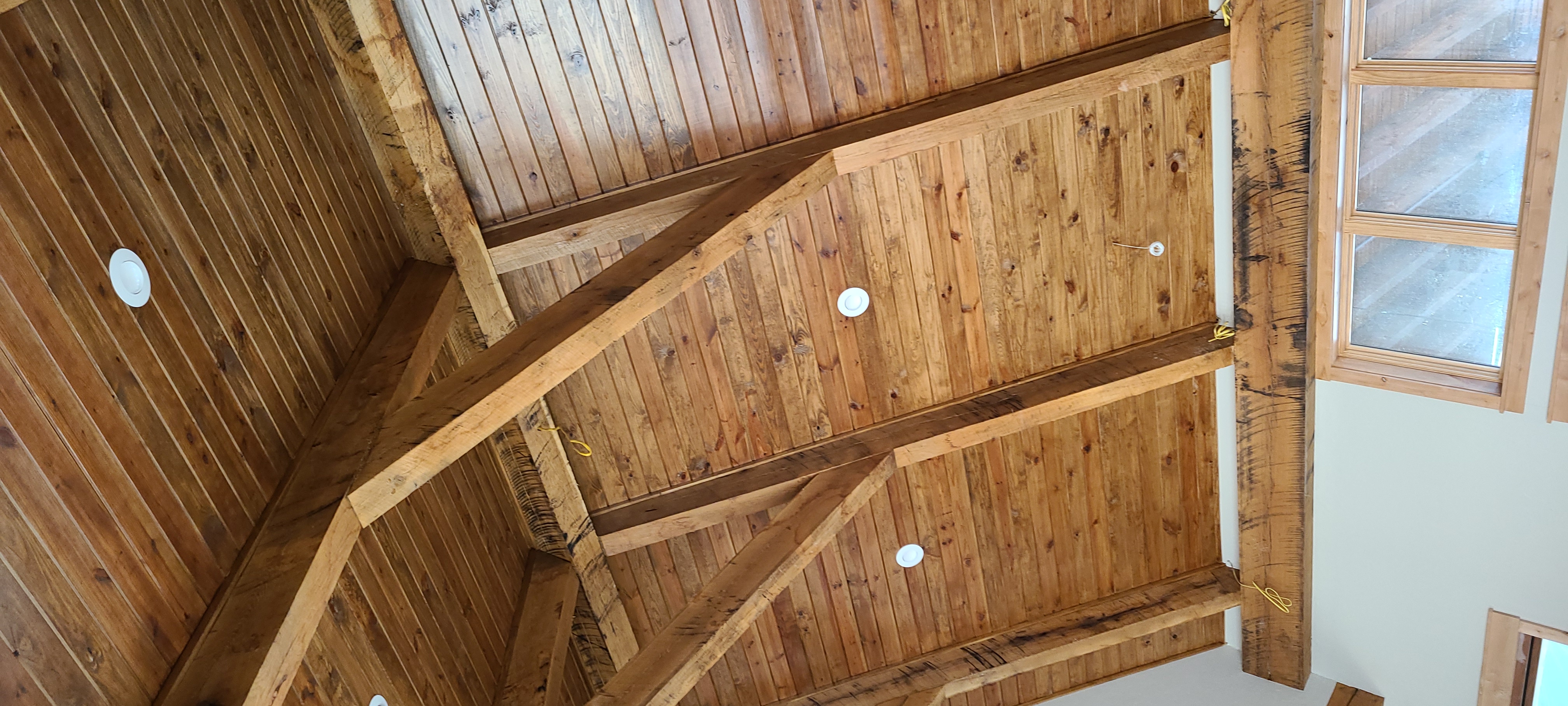 Tongue and groove wood ceiling with beams