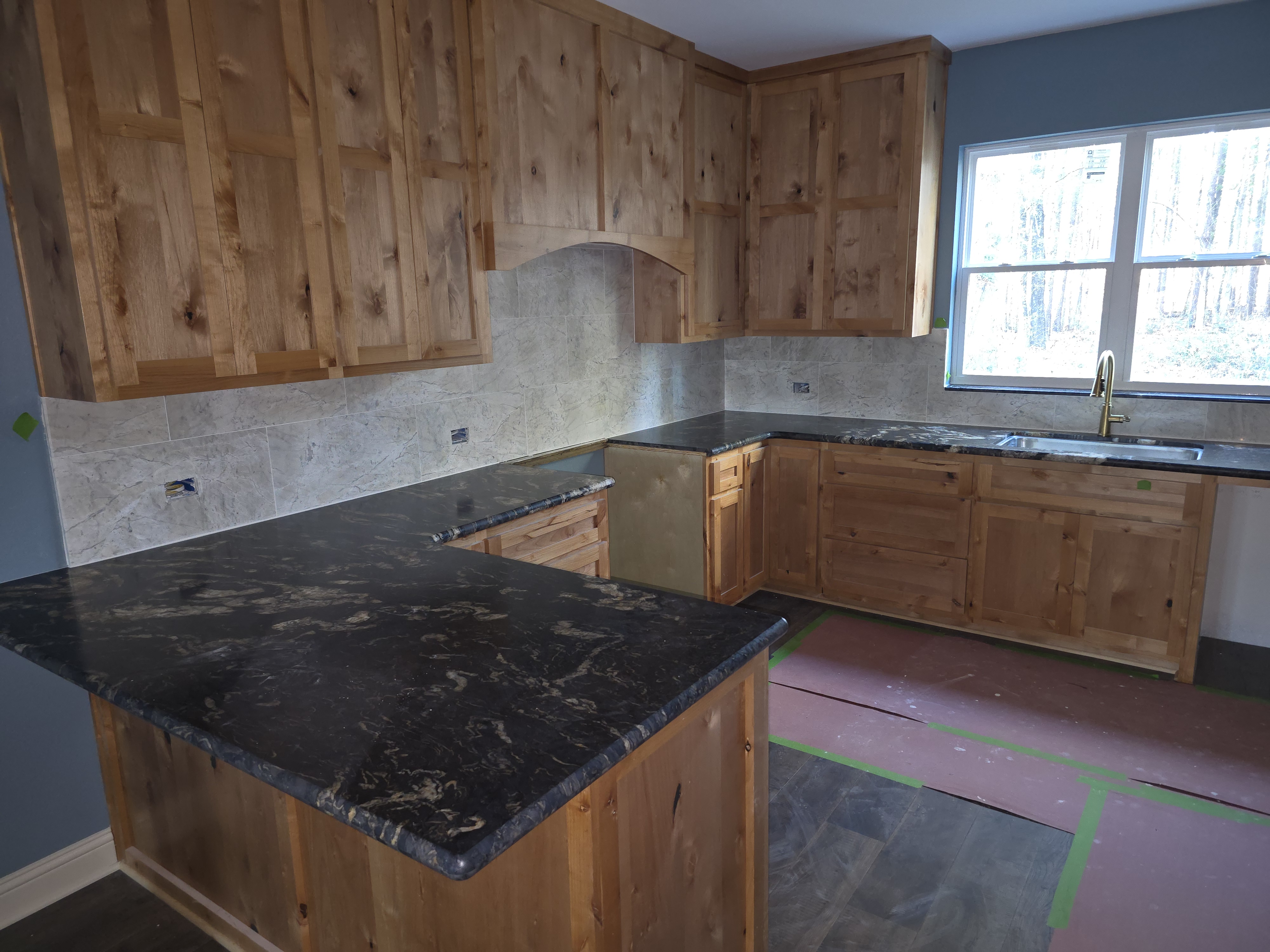 Knotty alder kitchen cabinets and dark countertops