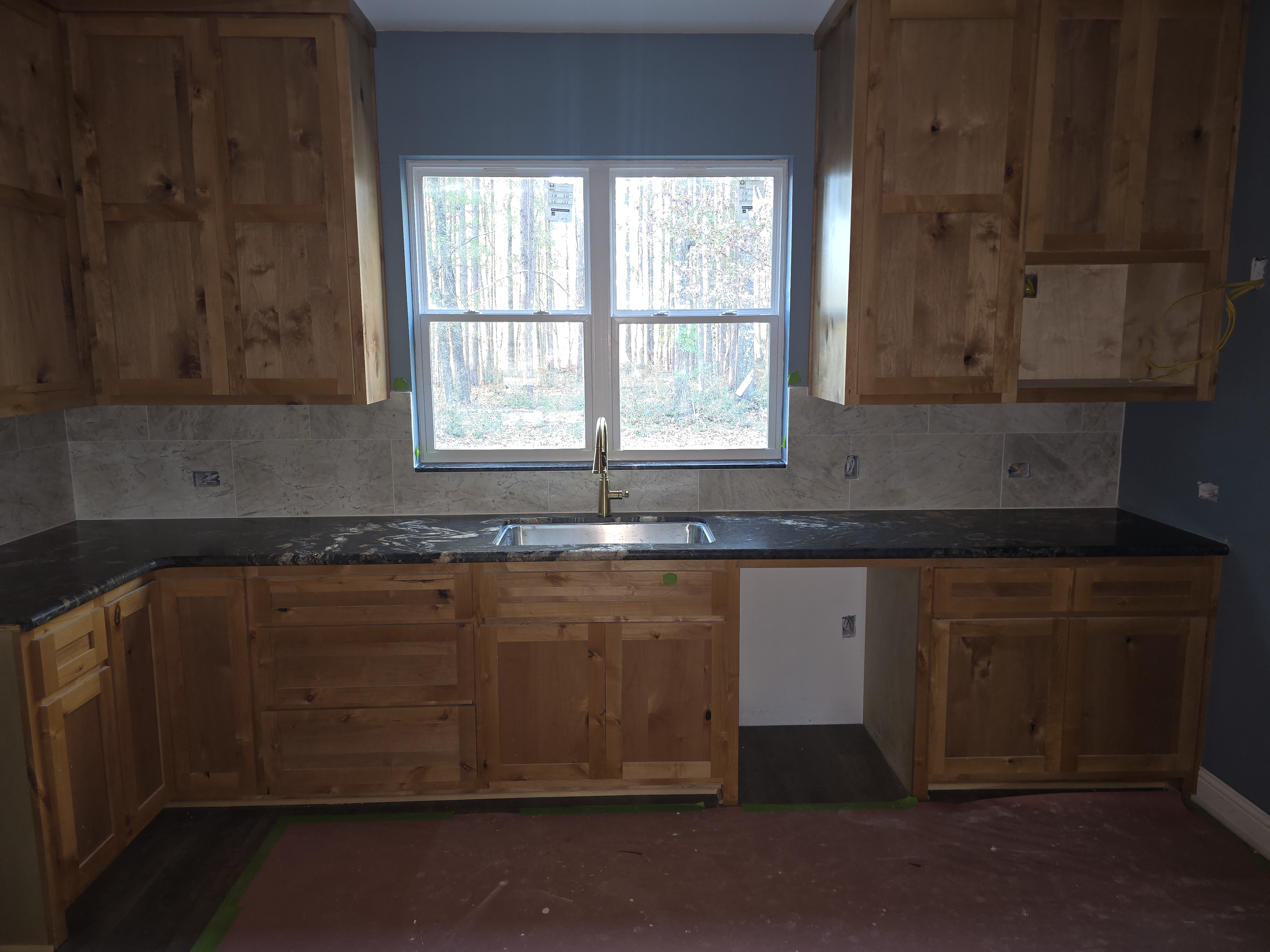 Kitchen sink wall with knotty alder cabinets